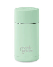 Load image into Gallery viewer, A mint green vacuum insulated travel tumbler with a silver band and the 'frank. green' logo printed on the front, set against a plain white background.
